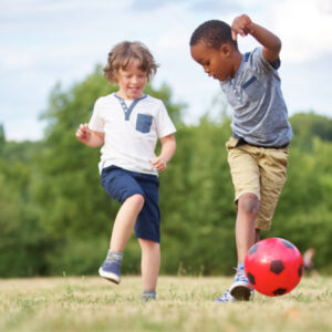 2 young boys playing football