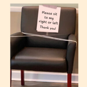 chair with sign: please sit to my right or my left