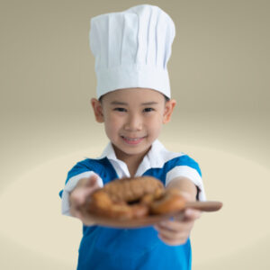 Young child in a chefs hat