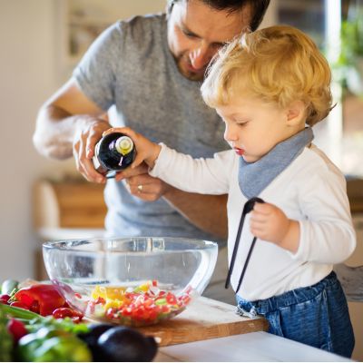 Father and child cooking together