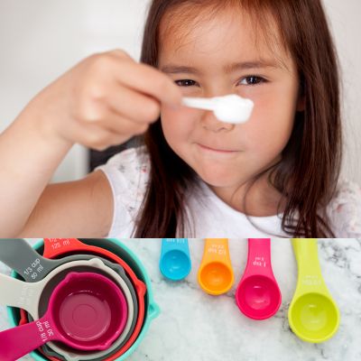 Young child measuring cooking ingredients