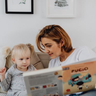 woman reading with young child